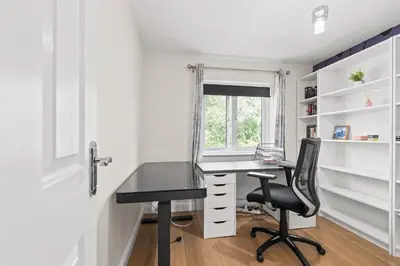 a home office with a desk and a chair at Polmont Haven: Spacious 4- Bedroom Retreat in Polmont