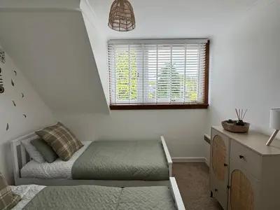 a small bedroom with a bed and a window at Tickety-Boo Luss Loch Lomond in Luss