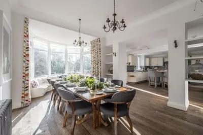 a dining room with a table and chairs at Cairns Farmhouse in Kirknewton