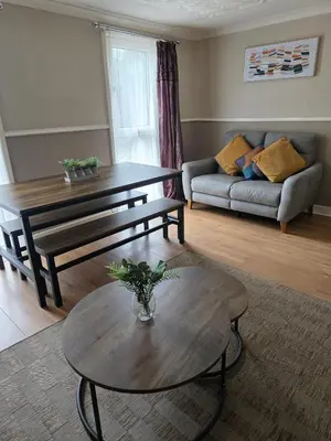 a living room with a coffee table and a couch at 3BR House with Parking 10 Mins to Airport Sleeps 6 in EDI