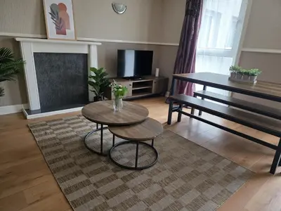 a living room with a table and a bench at 3BR House with Parking 10 Mins to Airport Sleeps 6 in EDI