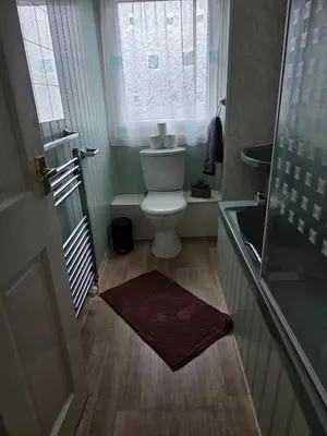 a small bathroom with a toilet and a window at 3BR House with Parking 10 Mins to Airport Sleeps 6 in EDI