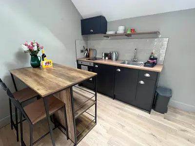 a small kitchen with a table and a sink at Kilmory Sea View in Lochgilphead