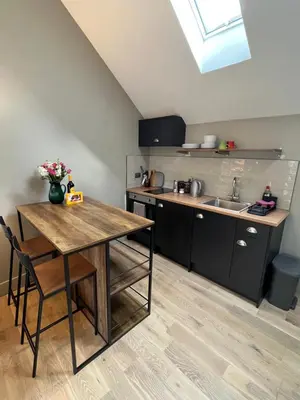 a kitchen with a table and a sink at Kilmory Sea View in Lochgilphead