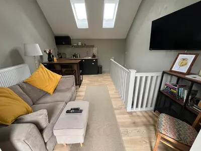 a living room with a couch and a flat screen tv at Kilmory Sea View in Lochgilphead