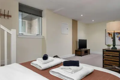 a bedroom with two white towels on a bed at Stirlings Hidden and Tranquil Studio Apartment in Stirling