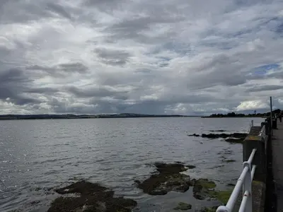 a large body of water with a cloudy sky at Watt-A-View in Limekilns