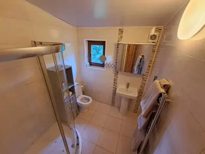 a small bathroom with a toilet and a sink at 87 Loch Murray in Creetown