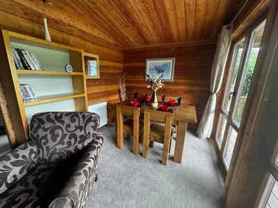 a room with a table and a couch in a cabin at 87 Loch Murray in Creetown