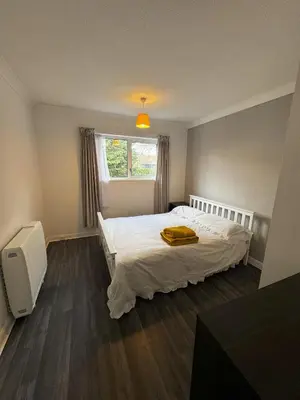 a bedroom with a white bed and a window at Honey House in Moffat