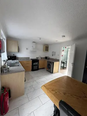 a kitchen with a table and a counter top at Honey House in Moffat