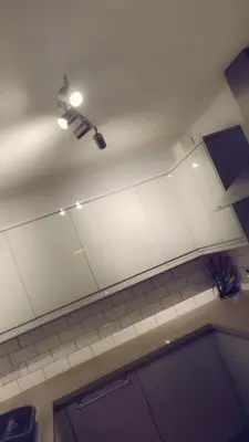 a kitchen with a white ceiling with a light on it at The friendly place in Glasgow