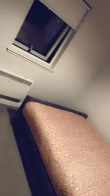 a bed in a small room with a window at The friendly place in Glasgow