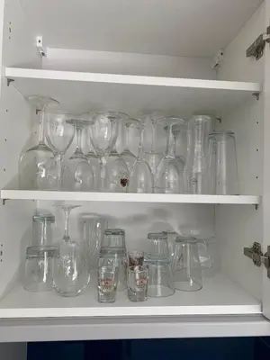 a shelf full of glass jars and glasses at Stag & Stay- Waterlillie - Contractor friendly, Fast WiFi in Port Glasgow