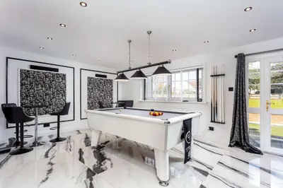 a pool table in a living room with white walls at No22 Shalloch House - Donnini Apartments in Ayr