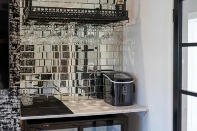 a kitchen counter with wine glasses on a wall at No22 Shalloch House - Donnini Apartments in Ayr