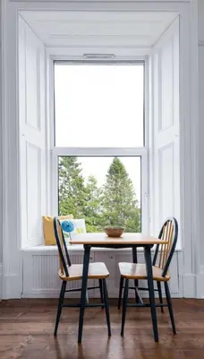 a dining room table with two chairs and a window at Stirling Retreat Quirky Decor, Fireplace and Charm in Stirling