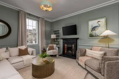 a living room with a couch and a fireplace at The Allan Maisonette Charming Georgian Retreat in Stirling