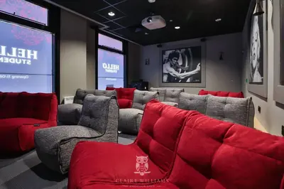 a waiting room with red chairs and a screen at For Students Only - Kings Stables Road in Edinburgh in Edinburgh
