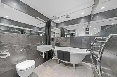 a bathroom with a tub and a toilet and a sink at Unique 1 Bedroom Near West End in Glasgow