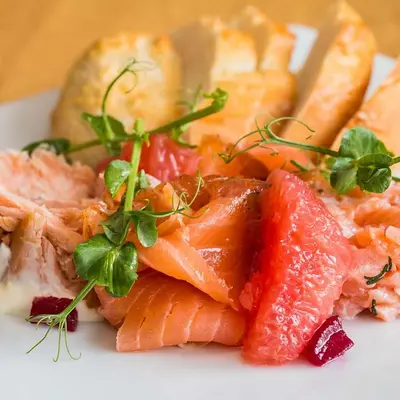 a plate of food with fish and vegetables on it at Glenisle Hotel in Isle of Arran