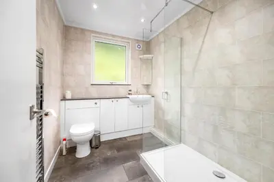 a bathroom with a toilet and a sink and a shower at Charming 2-Bed Cottage on Tranquil Raera Farm in Kilninver