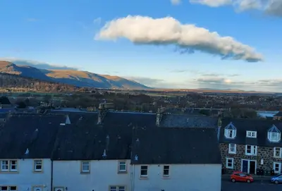 a cloud above a city with houses and buildings at 3 bed, 500mtrs to castle and stunning views in Stirling