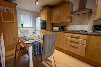 a kitchen with a table and a counter top at 3 bed, 500mtrs to castle and stunning views in Stirling