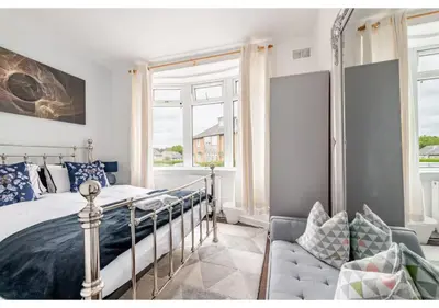 a bedroom with a bed and a window at Elegant Flat in a Serene Edinburgh Neighbourhood in Edinburgh