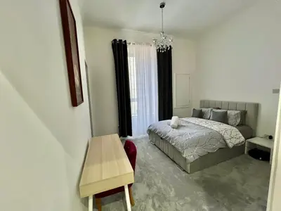 a bedroom with a bed and a table in it at Three bedroom Apartment In Glasgow City Centre in Glasgow