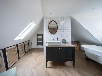 a bathroom with a sink and a bath tub in a attic at Shipmaster's Townhouse in Queensferry