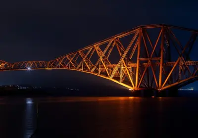 a large bridge over the water at night at Shipmaster's Townhouse in Queensferry