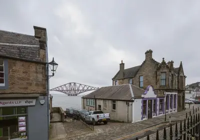 an old building with a bridge in the background at Shipmaster's Townhouse in Queensferry