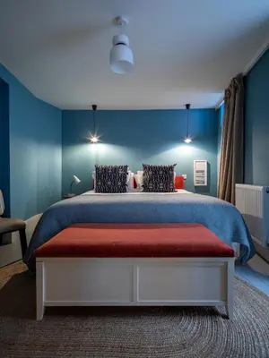 a bedroom with a large bed with blue walls at Shipmaster's Townhouse in Queensferry