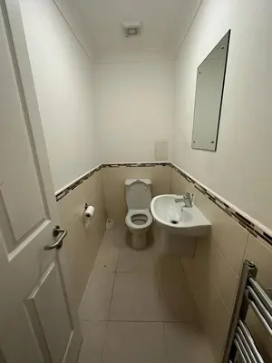 a bathroom with a toilet and a sink at Cozy Room In Sauchiehall Street in Glasgow