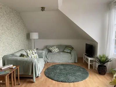 a living room with a couch and a tv at Skibo Vista Dunfermline in Dunfermline
