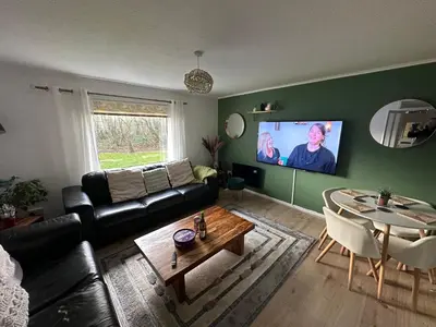a living room with a couch and a table at 3 bedroom apartment in Cumbernauld