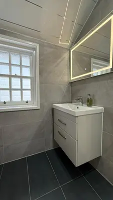 a bathroom with a white sink and a mirror at Armadillo Guest House- Adults Only in Edinburgh