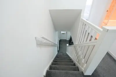 a staircase in a building with white walls at Modern 2 Bedroom Platinum Pad Glasgow City in Glasgow