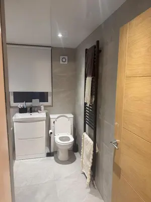 a small bathroom with a toilet and a sink at Stylish modern flat in the centre of Dunfermline in Dunfermline