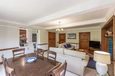 a living room with a couch and a table at Lonan Country House and Gardens in Taynuilt