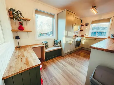 a kitchen with wooden floors and a counter top at Highland Coo Lodge in Dunoon