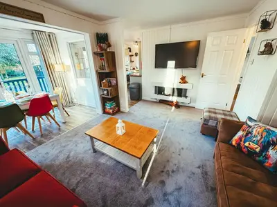 a living room with a couch and a coffee table at Highland Coo Lodge in Dunoon