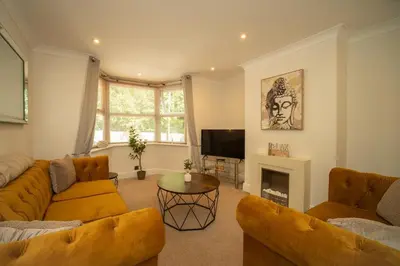 a living room with two couches and a television at Spacious 3 Bedroom home in Ascot, Sleeps 5, Parking in Moffat