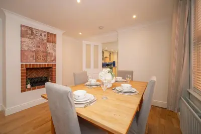 a dining room with a wooden table and chairs at Spacious 3 Bedroom home in Ascot, Sleeps 5, Parking in Moffat