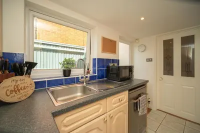a kitchen with a sink and a microwave at Spacious 3 Bedroom home in Ascot, Sleeps 5, Parking in Moffat