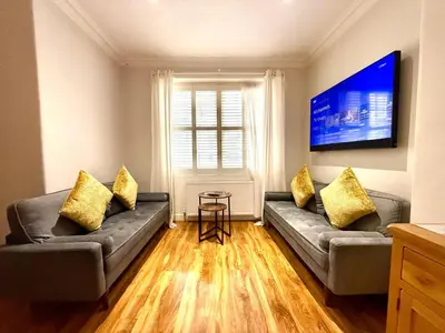a living room with two couches and a tv at Historic Mews House 2BR in Edinburgh City Centre in Edinburgh
