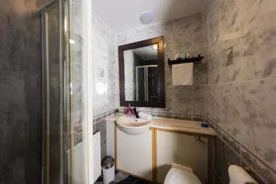 a bathroom with a sink and a mirror at Cosy Central Apartment by the Meadows 4 in Edinburgh