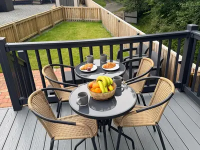 a table with a basket of fruit on a balcony at Lime Tree Lodge in Crieff