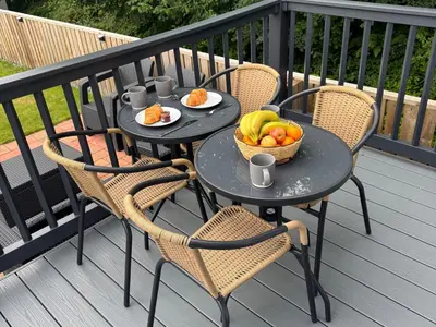 a table with a basket of fruit on a balcony at Lime Tree Lodge in Crieff